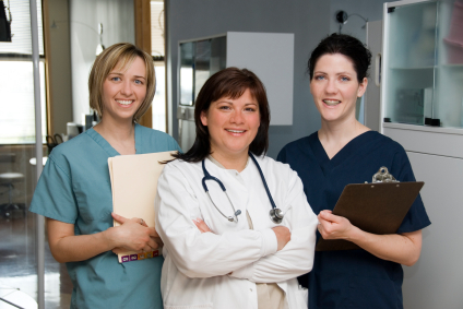 three nurses standing in a nursing unit